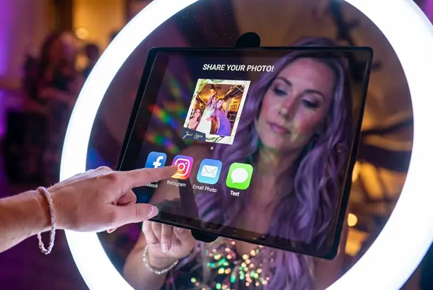 Guest sharing roaming photo booth image instantly via social media on iPad with ring light at Phoenix Arizona event — Ooh La La Booths instant photo sharing